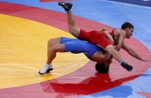 Ukraine's Lenur Temirov (in red) fights with Kazakhstan's Almat Kebispayev on the Men's 60Kg Greco-Roman wrestling at the ExCel venue during the London 2012 Olympic Games August 6, 2012.          REUTERS/Kim Kyung-Hoon (BRITAIN  - Tags: OLYMPICS SPORT WRESTLING)