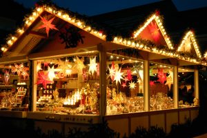 Illuminated Christmas fair kiosk with loads of shining decoration merchandise, no logos